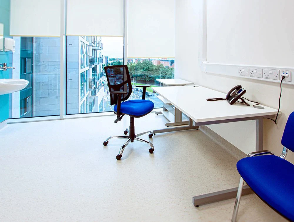 Bright-blue-chairs-and-cantilever-desk-in-office-with-windows