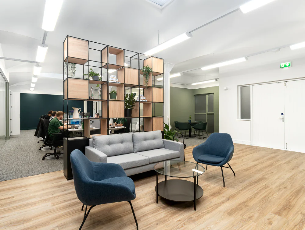 Glass-Top-Coffee-Table-with-Small-Indoor-Plant-and-Lounge-Chair-in-Breakout-Setting_464d7a9f-38ea-4fd4-a6a9-b271e87c895d