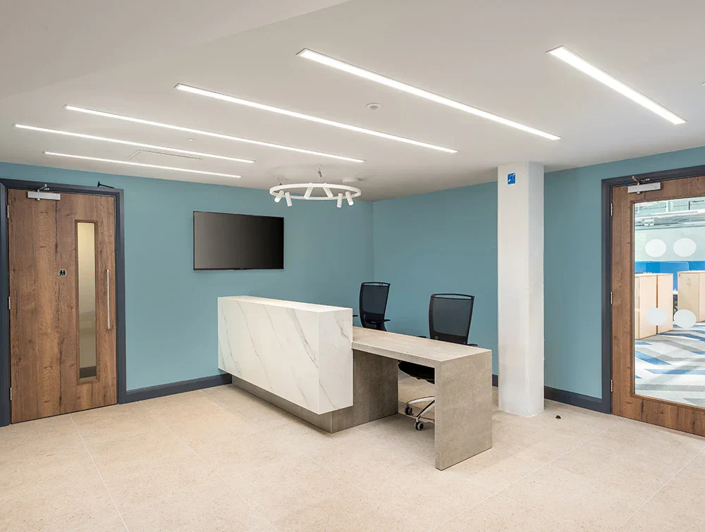 Precision-Software-Office-Reception-Desk-with-Overhead-LED-Lights-and-High-Back-Mesh-Chairs_f1609664-c314-44f2-b2f5-f791f035e3a6