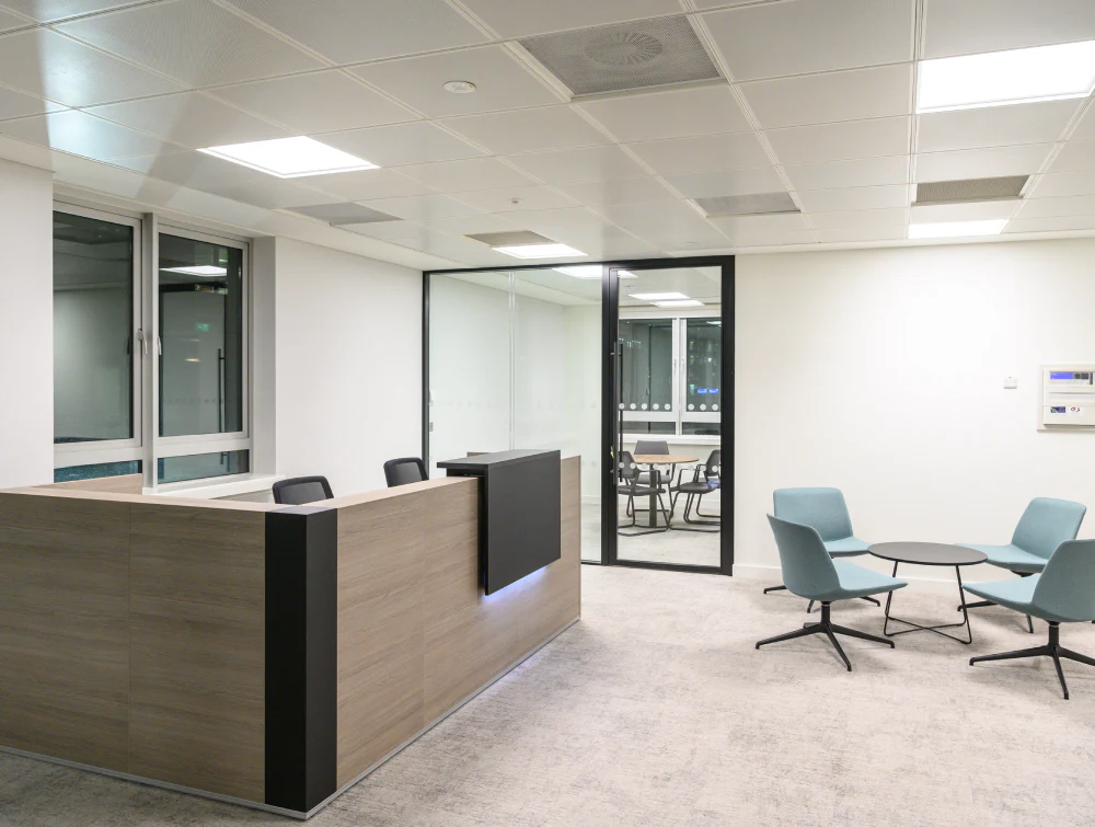 Reception-Counter-with-Round-Coffee-Table-and-Lounge-Chair-in-Reception-Setting